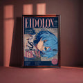 The image is a framed poster featuring an illustration of a blue-haired anime character with a pink background. The poster appears to be a magazine or book cover for a publication called "Eidolon".