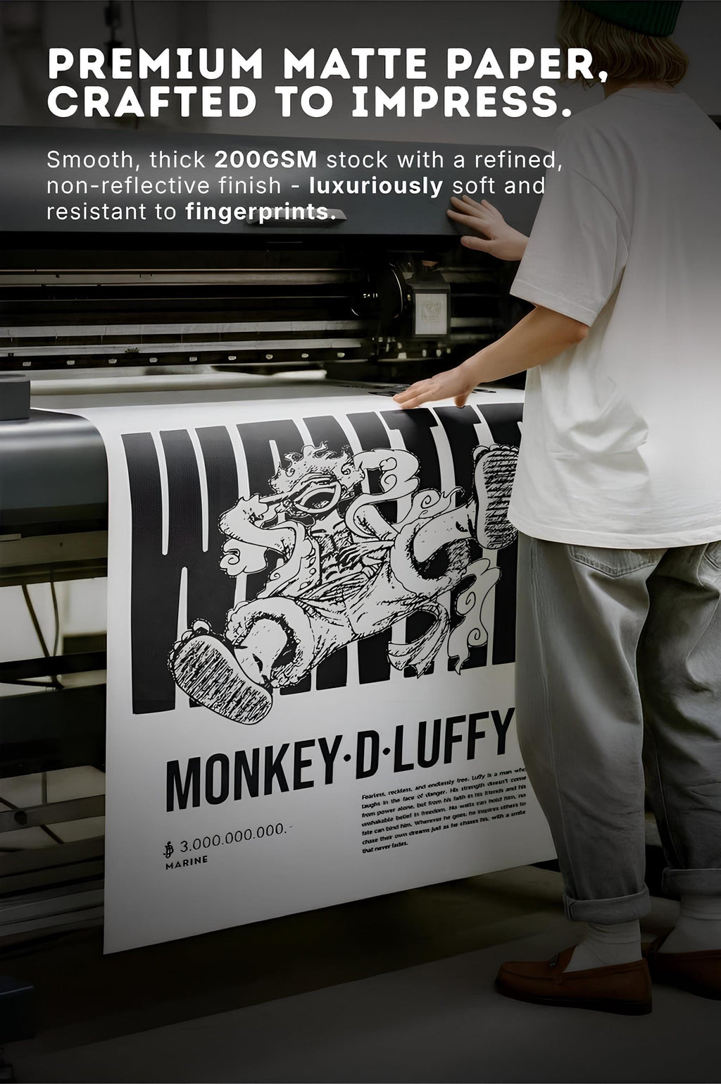 a person operating a printing press, with a large sheet of premium matte paper with a printed design on it.